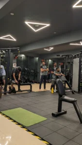 Torque Fitness trainers assisting members near Vijayanagara 1st Stage