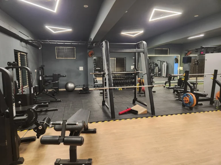 Bench press and leg workout equipment at Torque Fitness Mysore gym